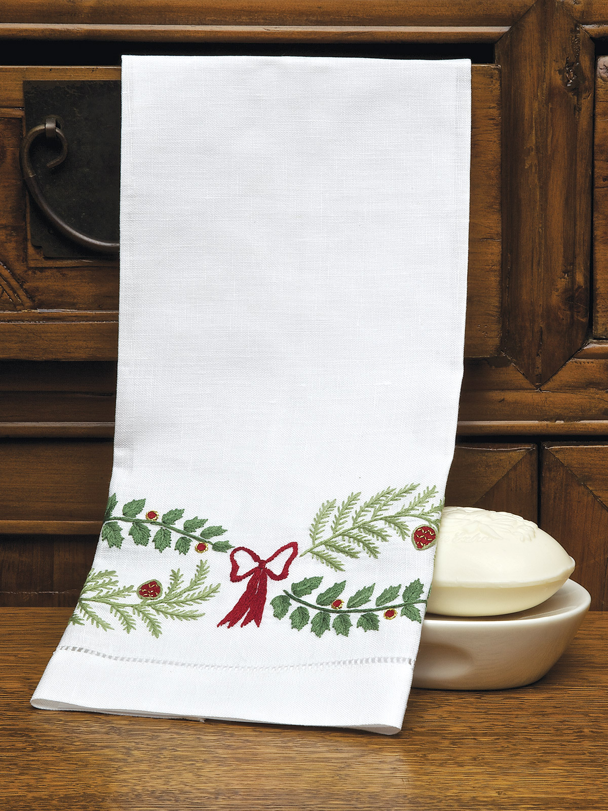 Image of the Holly Days guest towel with holly embroidery and festive color palette