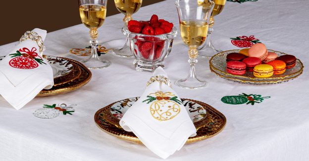 Image of the Noel Christmas table collection with holiday-themed embroidered placemats and linens