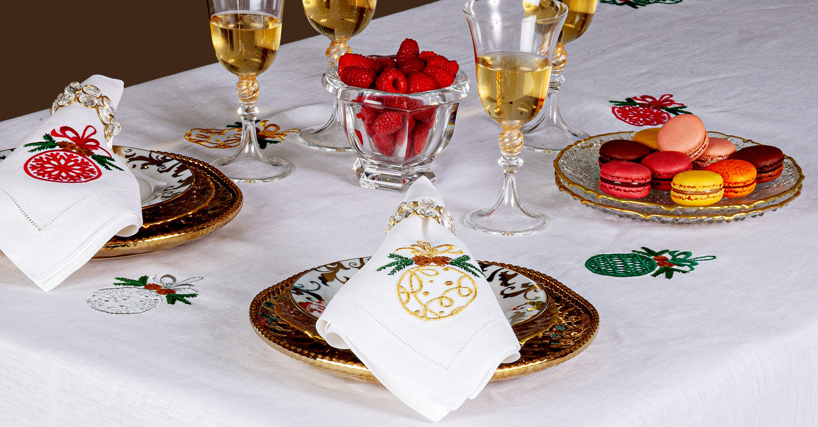 Image of the Noel Christmas table collection with holiday-themed embroidered placemats and linens