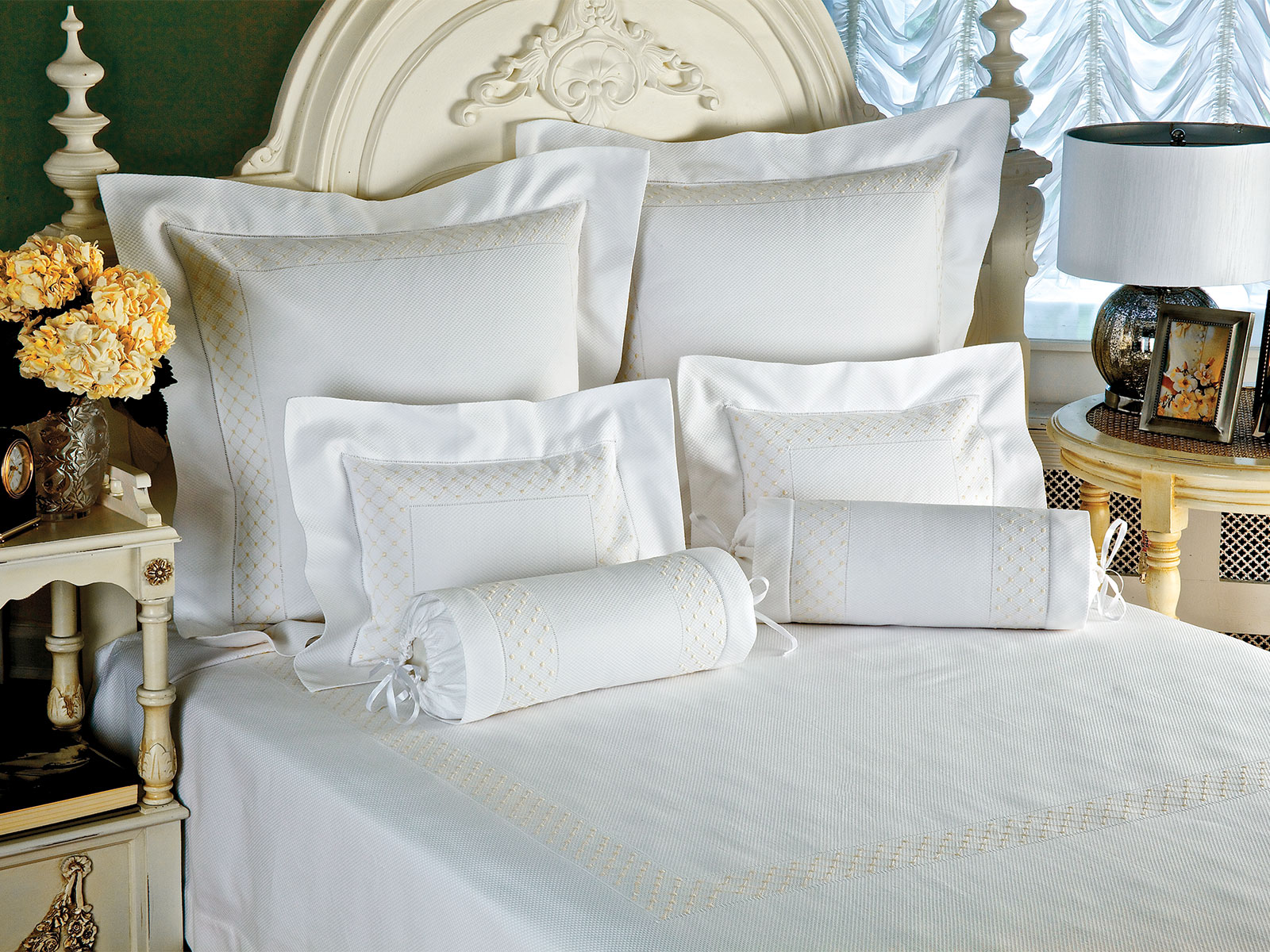 Image of the Reverie bedding collection with delicate embroidered dot and diamond detailing in soft ivory tones