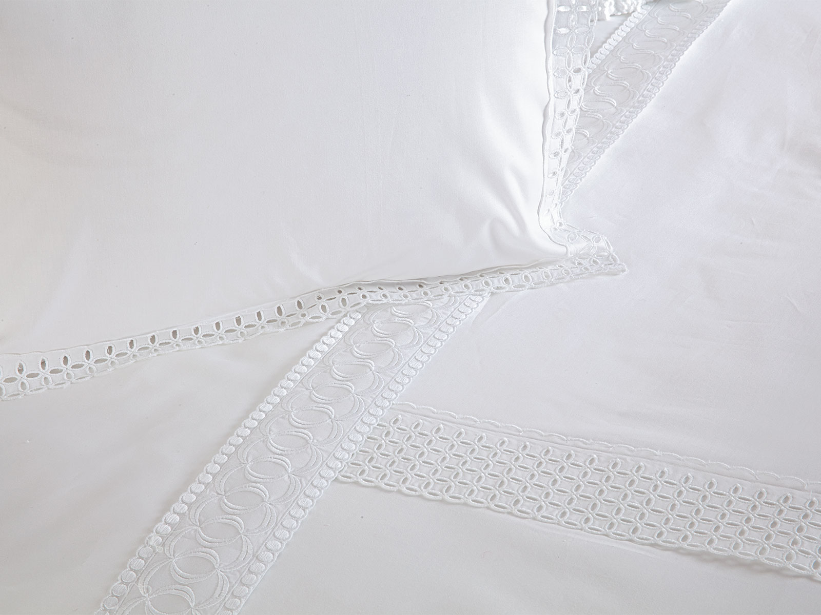 Image of the Mont Blanc bedding collection styled in soft winter whites with layered texture and refined detailing