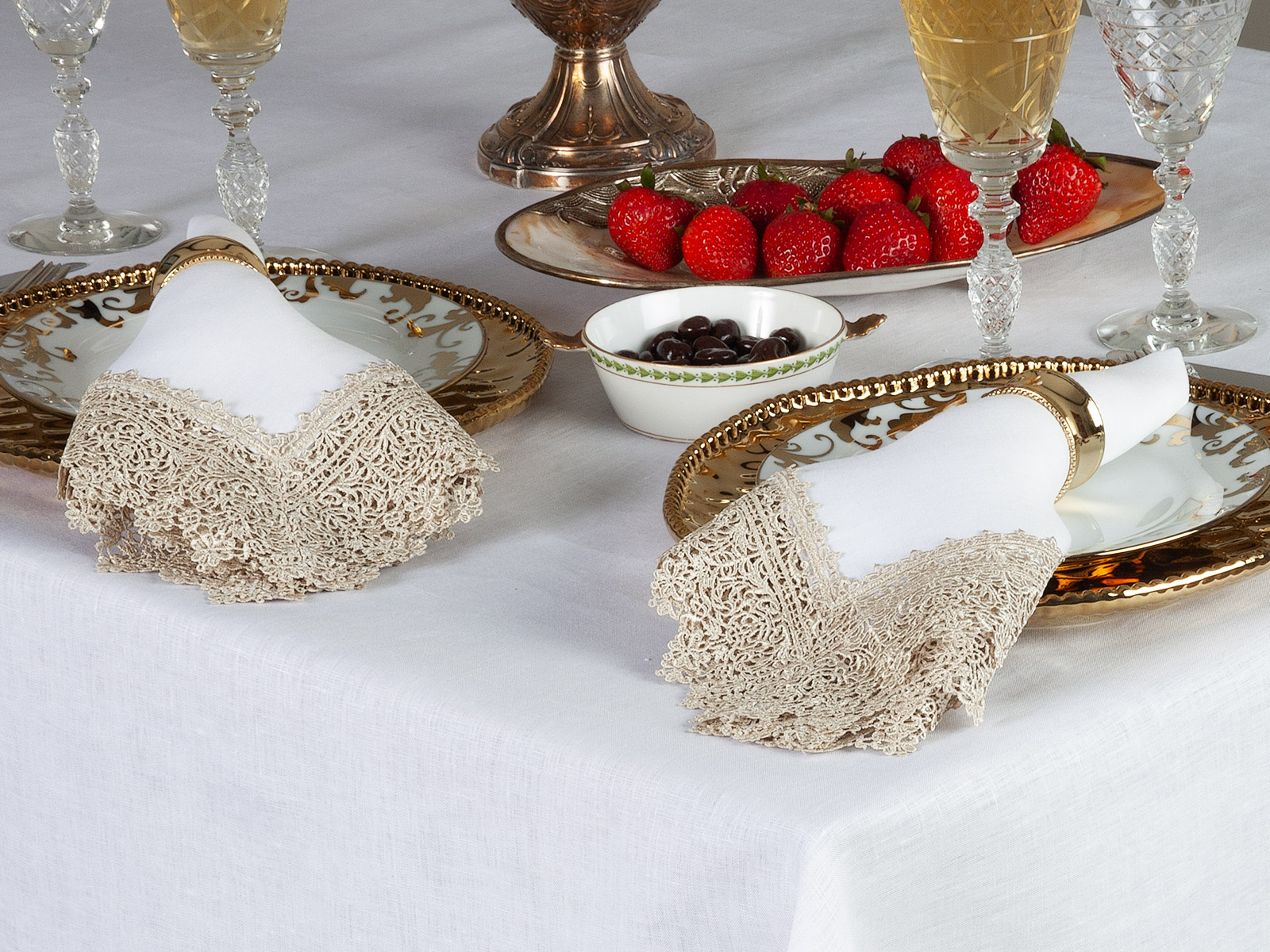 Image of Noble Feast linen napkins featuring intricate lace detailing on an elegant table setting