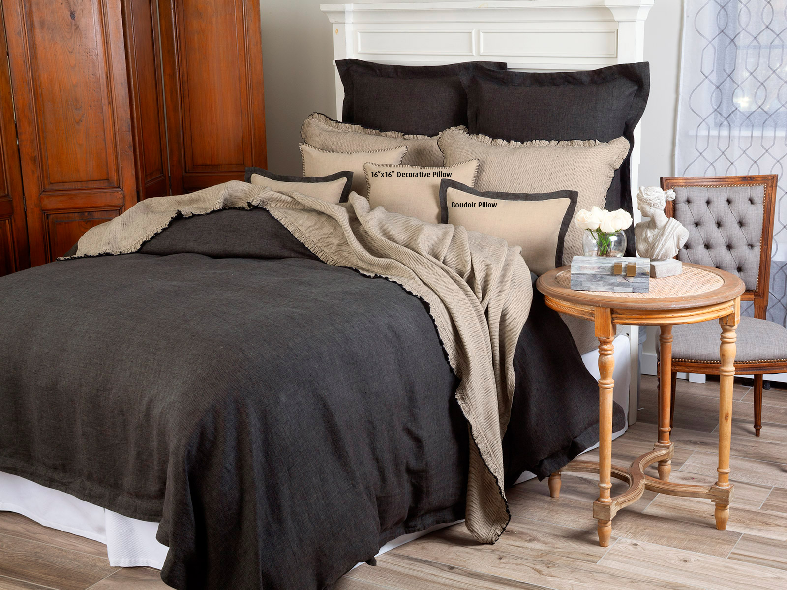 Image of Ashcroft linen bedding in soft neutral tones with relaxed texture and elegant tailoring.
