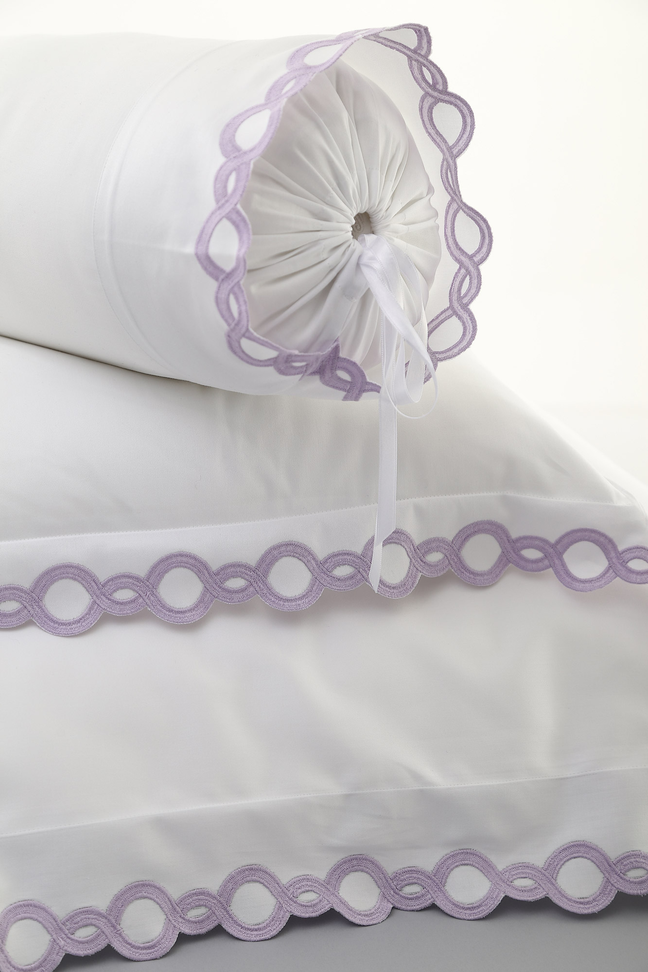 Image of fine bed linens featuring smooth fabric, elegant draping, delicate finishing, and refined textile craftsmanship